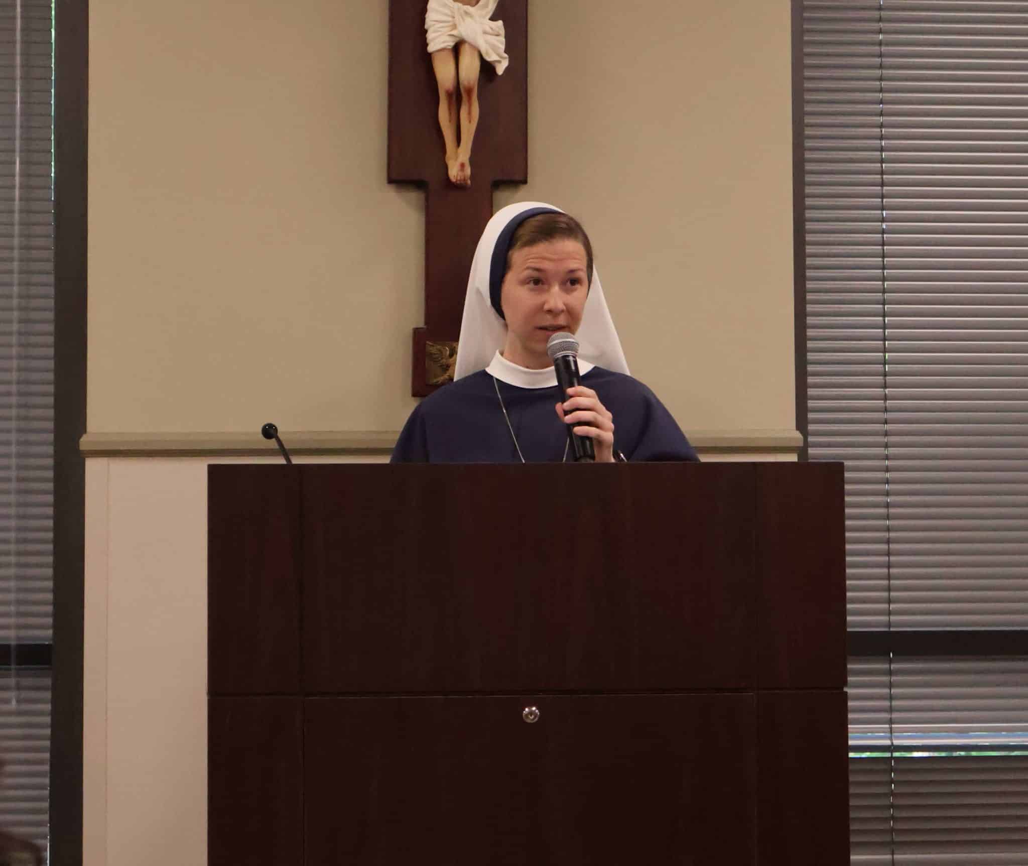 Sister Ann Imaculee speaks at the podium